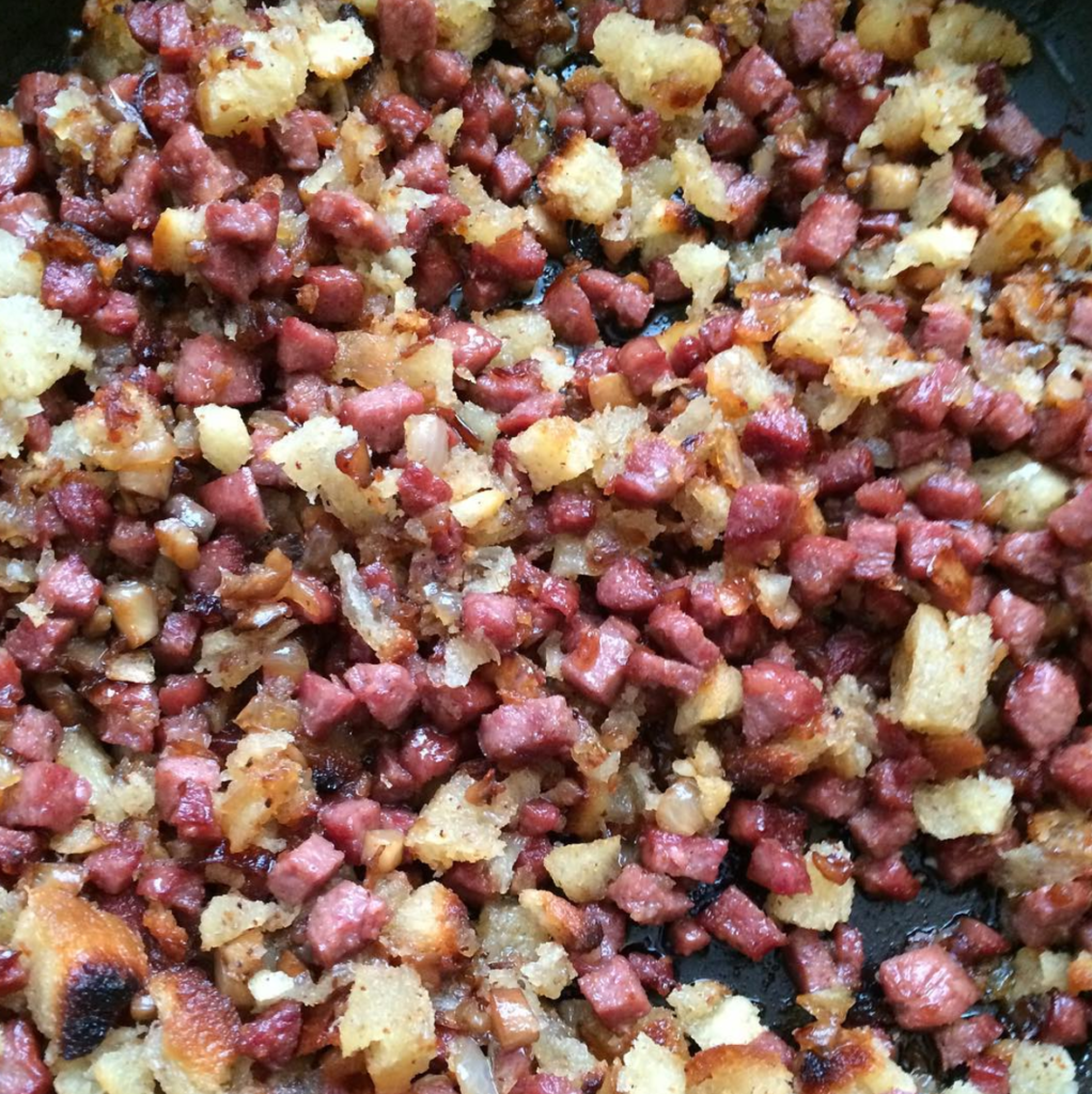 Sausage, onions and mushrooms cooked with homemade challah croutons ready to get stuffed in mushrooms!