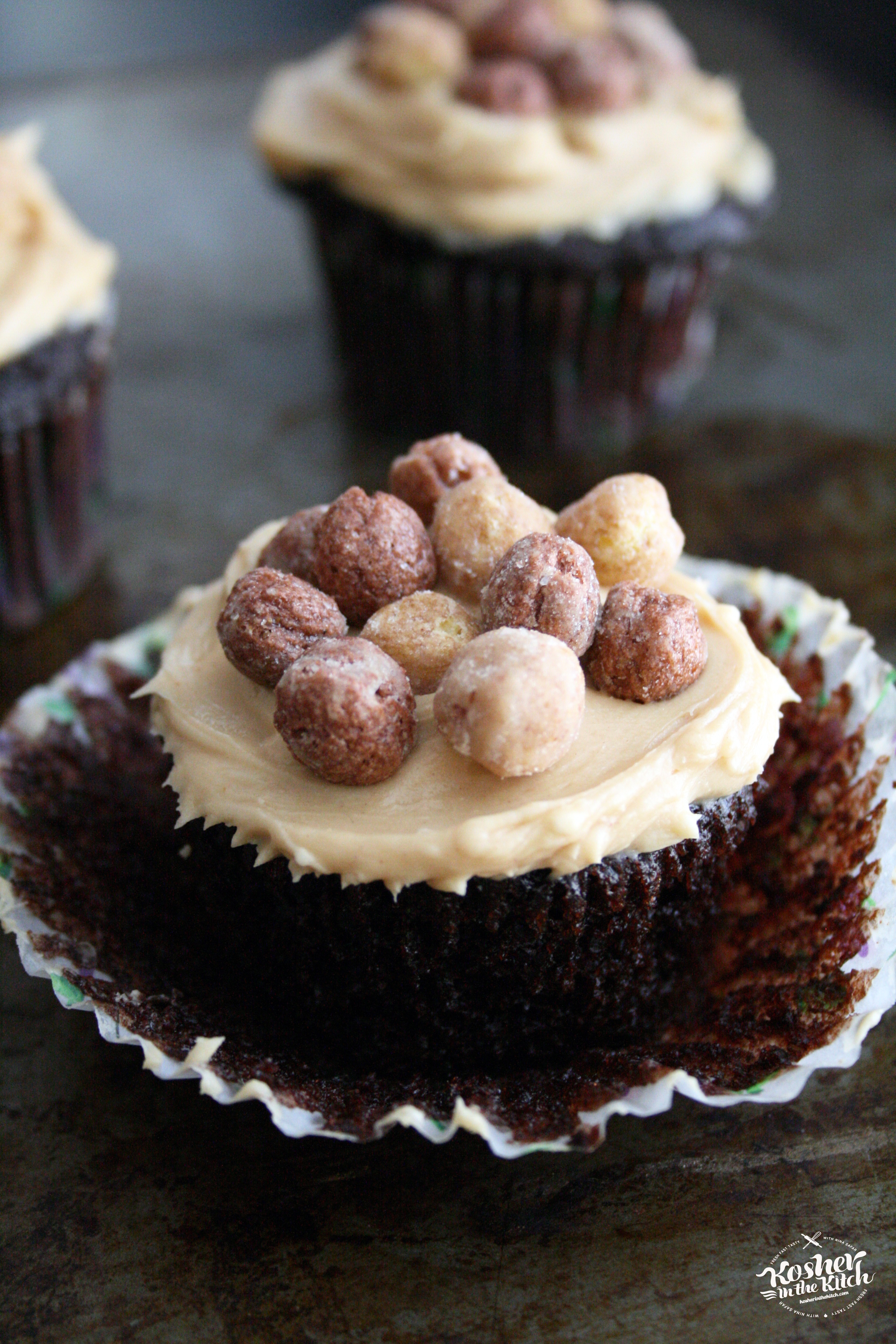 Chocolate Cupcake with Peanut Butter Frosting topped with Reese's Puffs Cereal