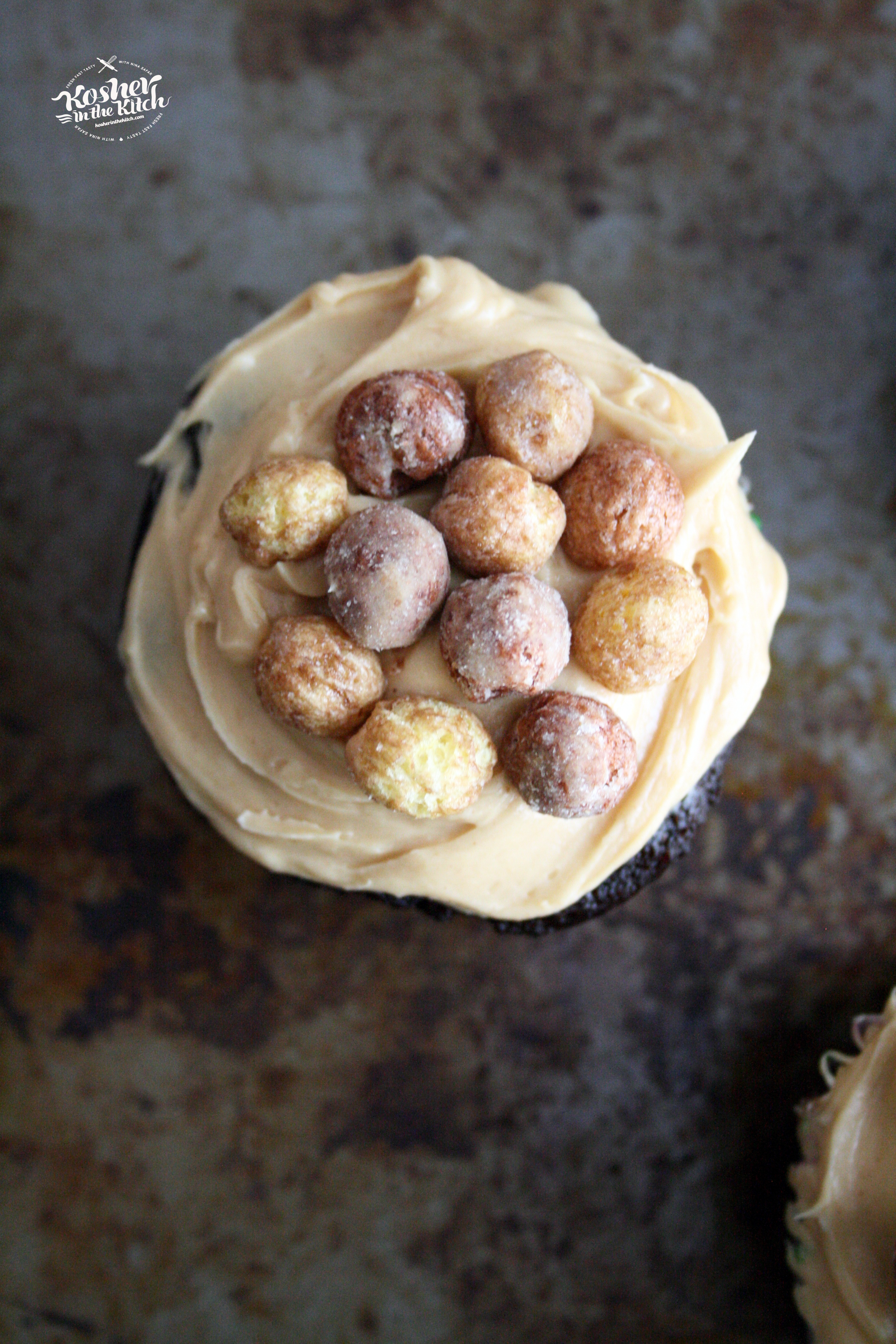 Chocolate Cupcake with Peanut Butter Frosting topped with Reese's Puffs Cereal