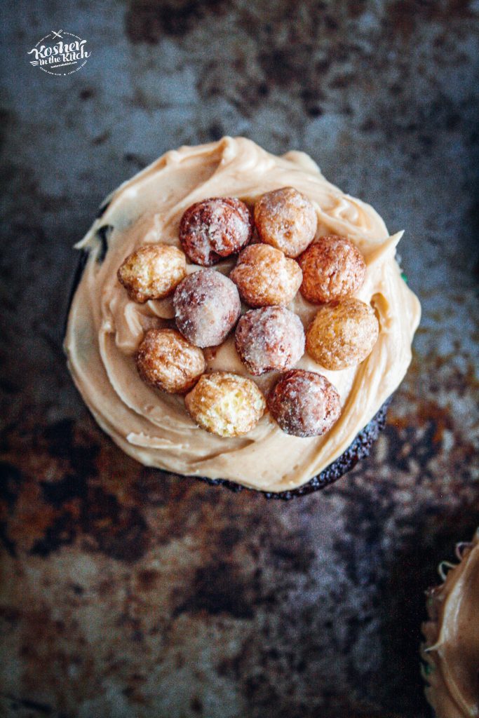 Chocolate Cupcake with Peanut Butter Frosting topped with Reese's Puffs Cereal