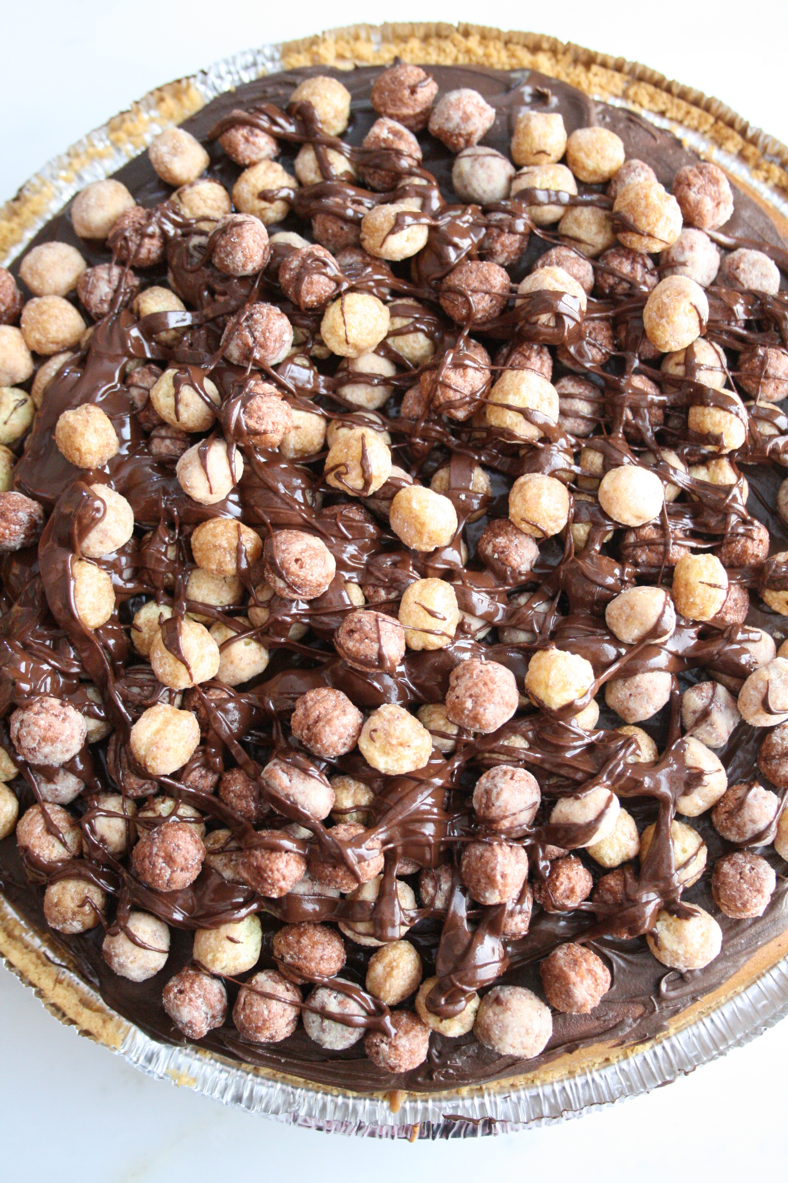 Peanut Butter Chocolate Rees’es Puffs Cheesecake
